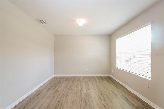 empty room with light hardwood / wood-style flooring