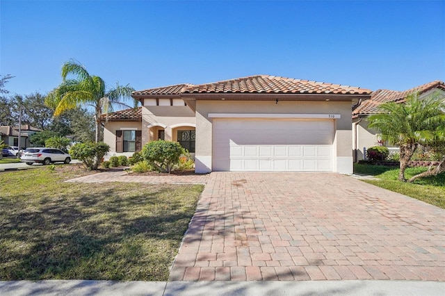 mediterranean / spanish house featuring a garage