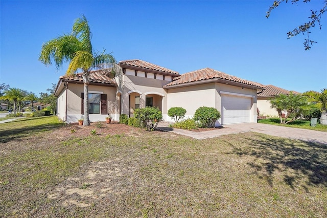 mediterranean / spanish house featuring a front yard and a garage