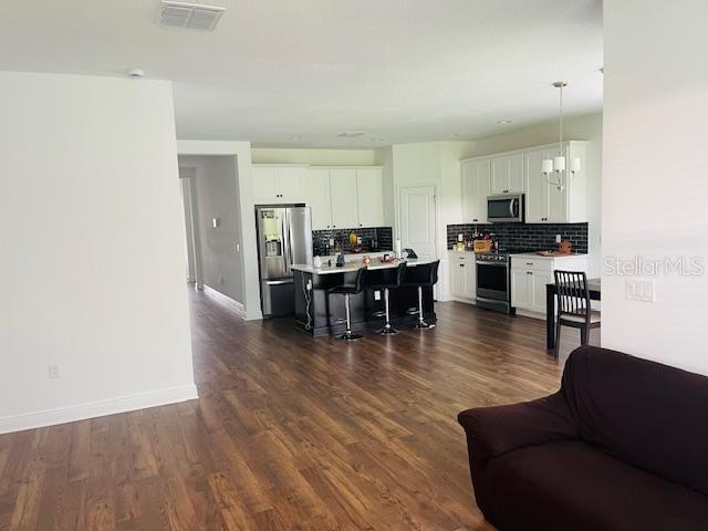 living room featuring dark hardwood / wood-style floors and a chandelier