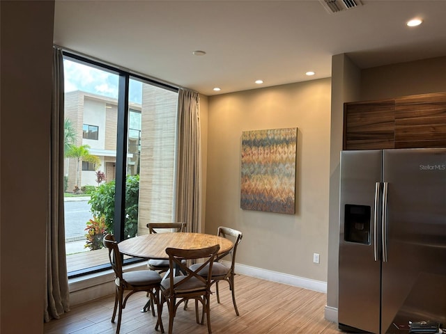 dining space featuring plenty of natural light and light hardwood / wood-style floors