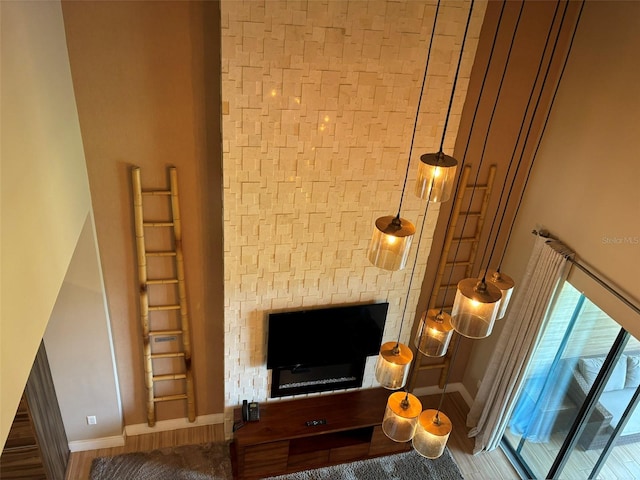 living room featuring a towering ceiling and hardwood / wood-style flooring