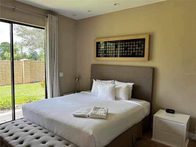 bedroom featuring multiple windows and access to outside