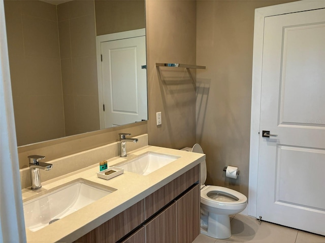 bathroom with vanity, toilet, and tile patterned floors