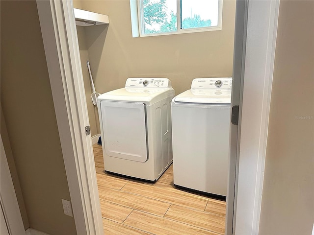 laundry room featuring independent washer and dryer and light wood-type flooring