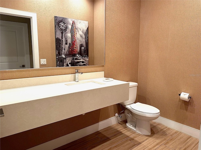 bathroom featuring toilet and hardwood / wood-style floors