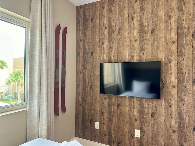 bedroom featuring wood walls