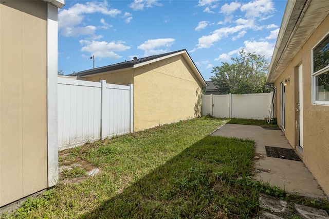 view of yard with a patio area and a fenced backyard