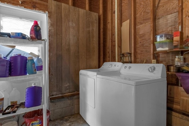 washroom featuring separate washer and dryer and wooden walls