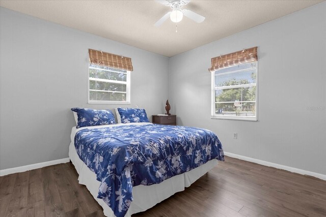 bedroom with dark wood-type flooring and ceiling fan