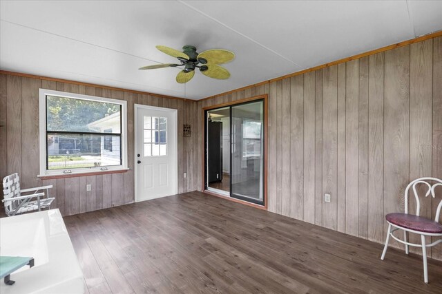 unfurnished sunroom with ceiling fan