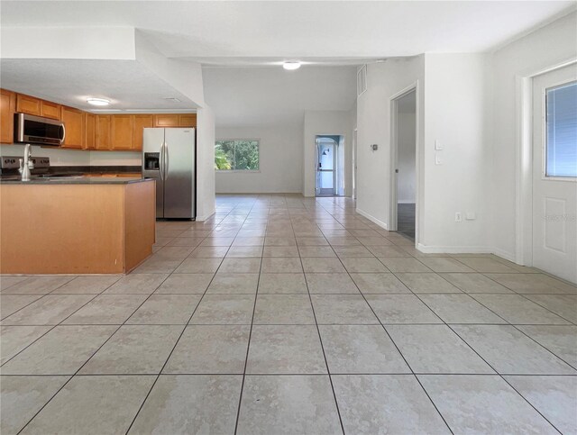 kitchen featuring appliances with stainless steel finishes and light tile patterned flooring