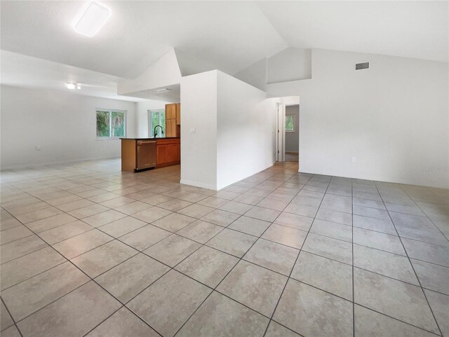 tiled spare room featuring sink and high vaulted ceiling