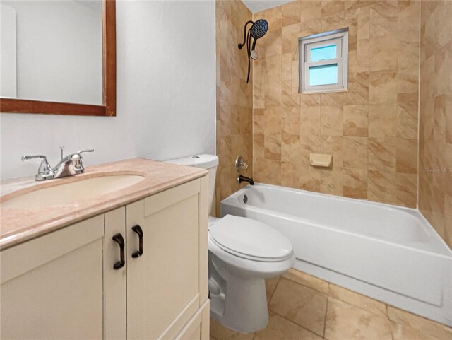 full bathroom featuring vanity, toilet, tiled shower / bath combo, and tile patterned floors