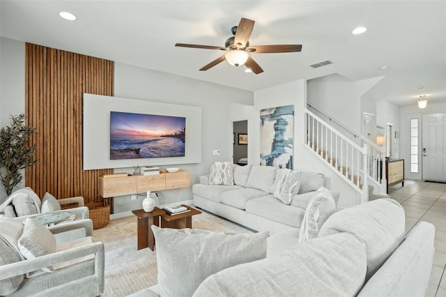 living area featuring a ceiling fan, recessed lighting, light tile patterned floors, visible vents, and stairway