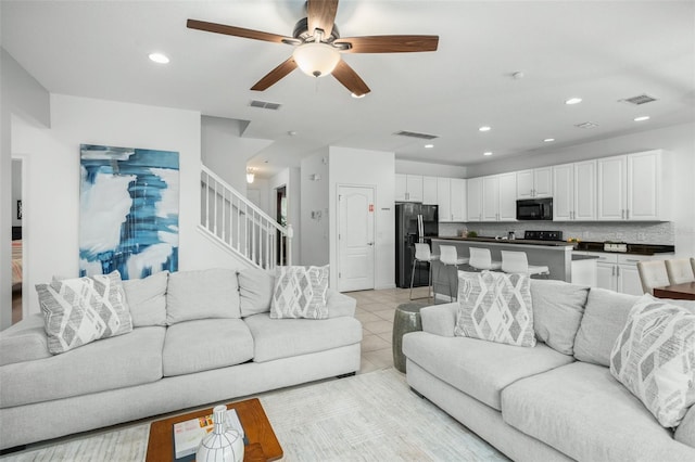 living room with light tile patterned floors and ceiling fan