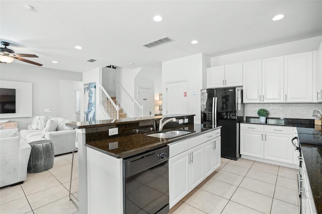 kitchen with visible vents, a sink, black appliances, open floor plan, and light tile patterned flooring