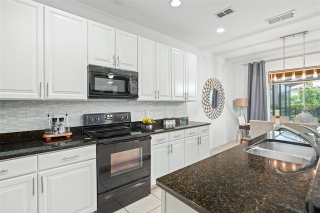 kitchen featuring dark stone countertops, white cabinetry, sink, black appliances, and light tile patterned flooring