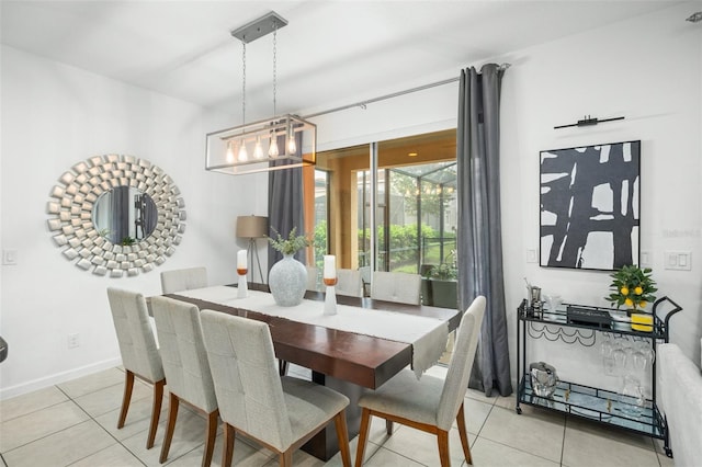 dining room with baseboards, tile patterned flooring, and a notable chandelier