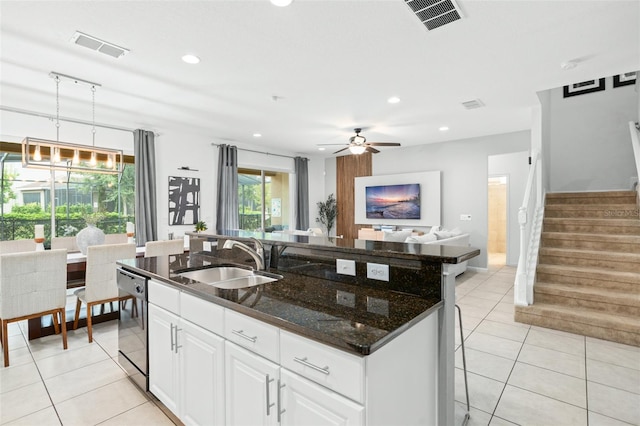 kitchen featuring pendant lighting, white cabinetry, sink, ceiling fan, and stainless steel dishwasher