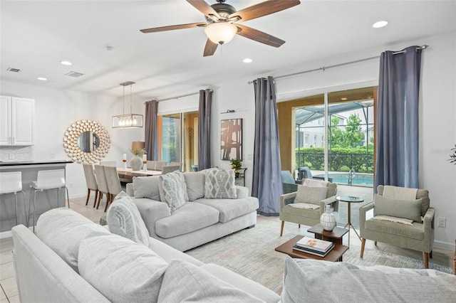 living room featuring recessed lighting, ceiling fan, visible vents, and baseboards