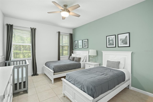bedroom with baseboards, ceiling fan, and light tile patterned flooring