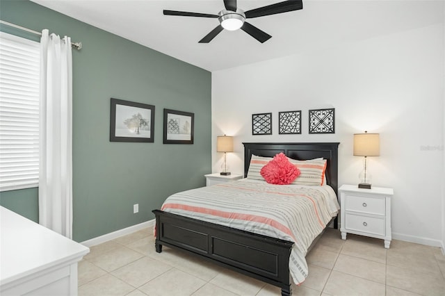 bedroom featuring light tile patterned flooring, baseboards, and a ceiling fan