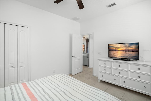 bedroom featuring light tile patterned flooring, a ceiling fan, visible vents, and baseboards