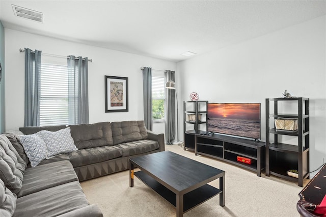 living room featuring carpet floors and visible vents