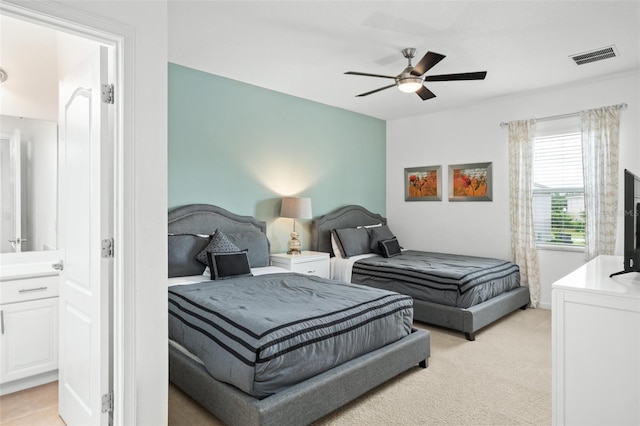 bedroom featuring ceiling fan, light colored carpet, and visible vents