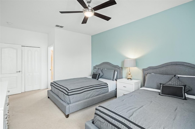 bedroom featuring visible vents, carpet floors, a closet, and ceiling fan
