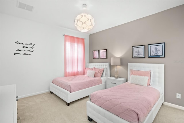 carpeted bedroom with visible vents and baseboards
