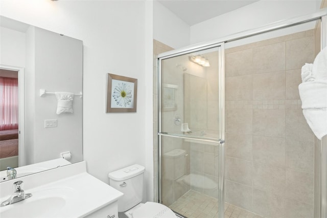 full bathroom with vanity, a shower stall, toilet, and connected bathroom