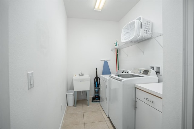 laundry room with separate washer and dryer and light tile patterned flooring