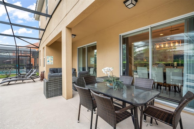 view of patio with glass enclosure, outdoor dining space, and an outdoor pool