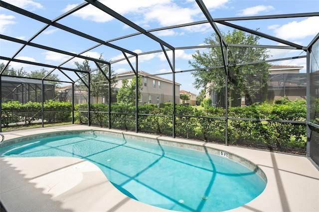 view of swimming pool with glass enclosure