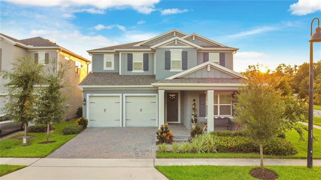 10472 Petrillo Way, Winter Garden, FL 34787 - view of front facade featuring stucco siding, driveway, covered porch, an attached garage, and a shingled roof