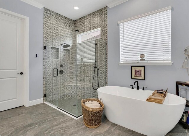 bathroom with shower with separate bathtub and ornamental molding