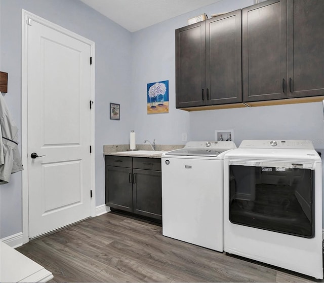 10472 Petrillo Way, Winter Garden, FL 34787 - laundry room with a sink, wood finished floors, cabinet space, separate washer and dryer, and baseboards