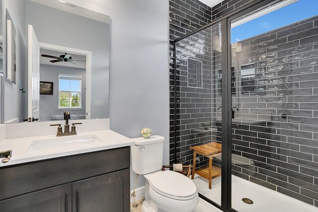 bathroom with vanity, toilet, walk in shower, and ceiling fan