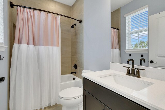 full bathroom with vanity, toilet, and shower / tub combo