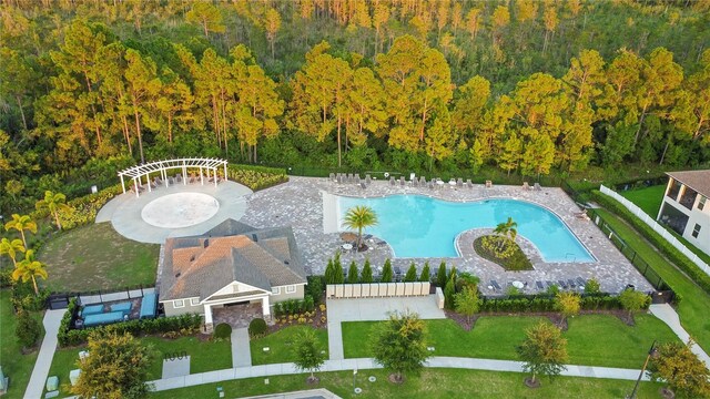 view of swimming pool featuring a lawn and a patio