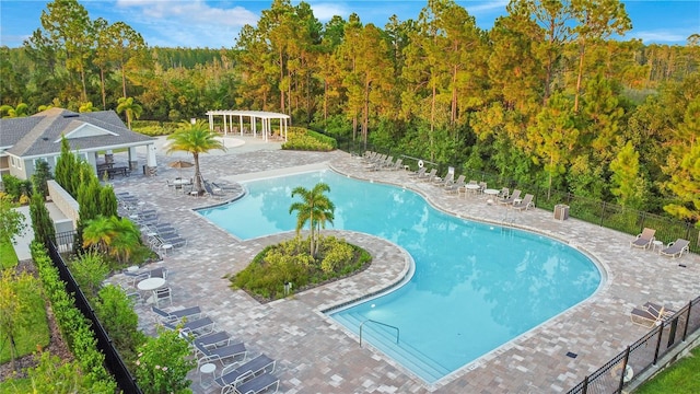 10472 Petrillo Way, Winter Garden, FL 34787 - pool with a forest view, a patio area, fence, and a pergola