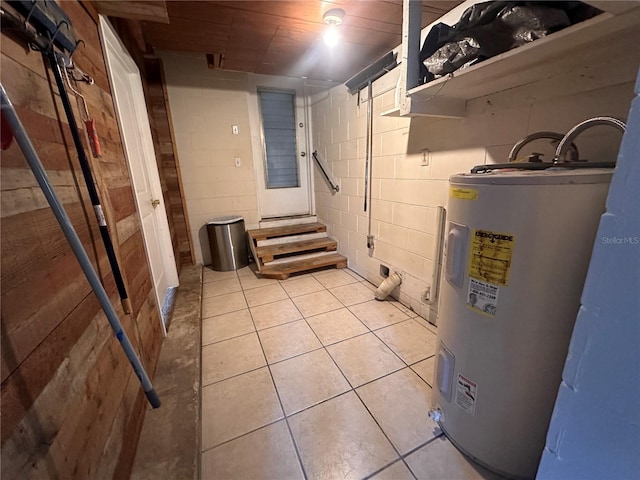 basement with light tile patterned floors and water heater