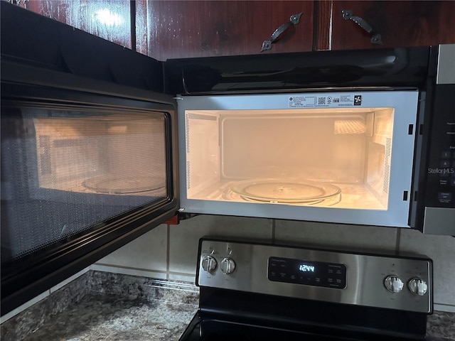 details featuring stainless steel range and tasteful backsplash