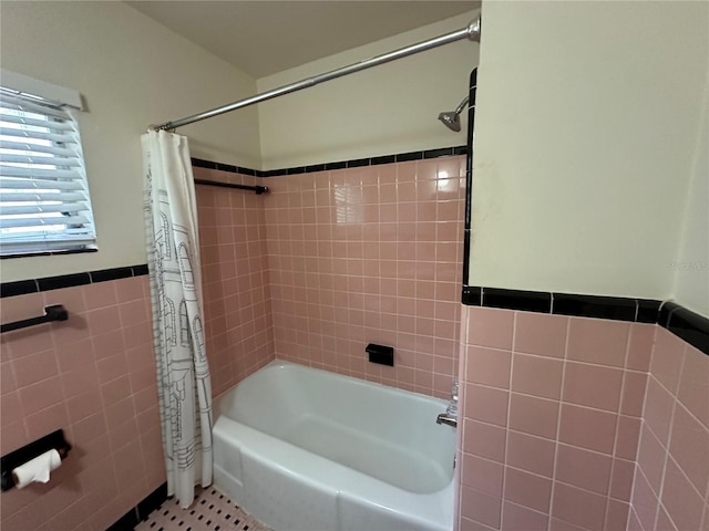 bathroom featuring tile walls, shower / tub combo, and tile patterned floors