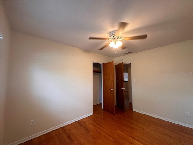 unfurnished bedroom with ceiling fan and hardwood / wood-style flooring