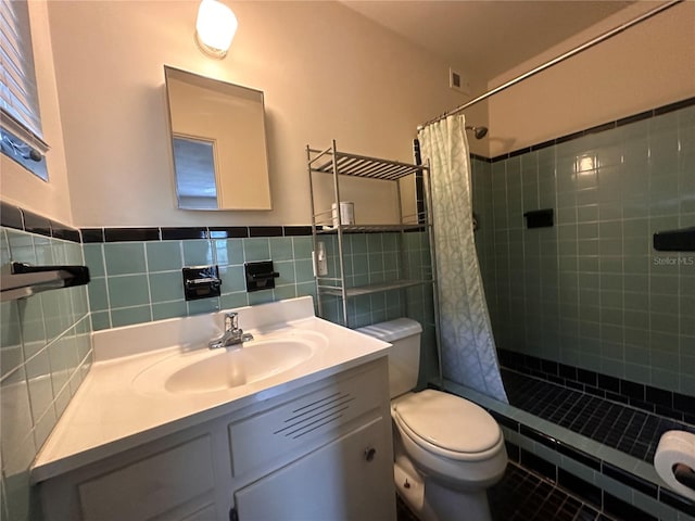 bathroom with toilet, walk in shower, tile patterned floors, vanity, and decorative backsplash