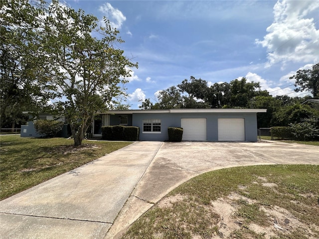 single story home featuring a garage and a front lawn