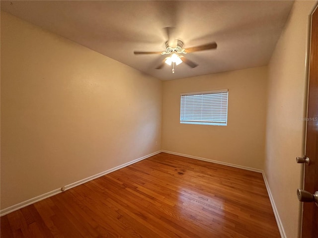 spare room with hardwood / wood-style floors and ceiling fan